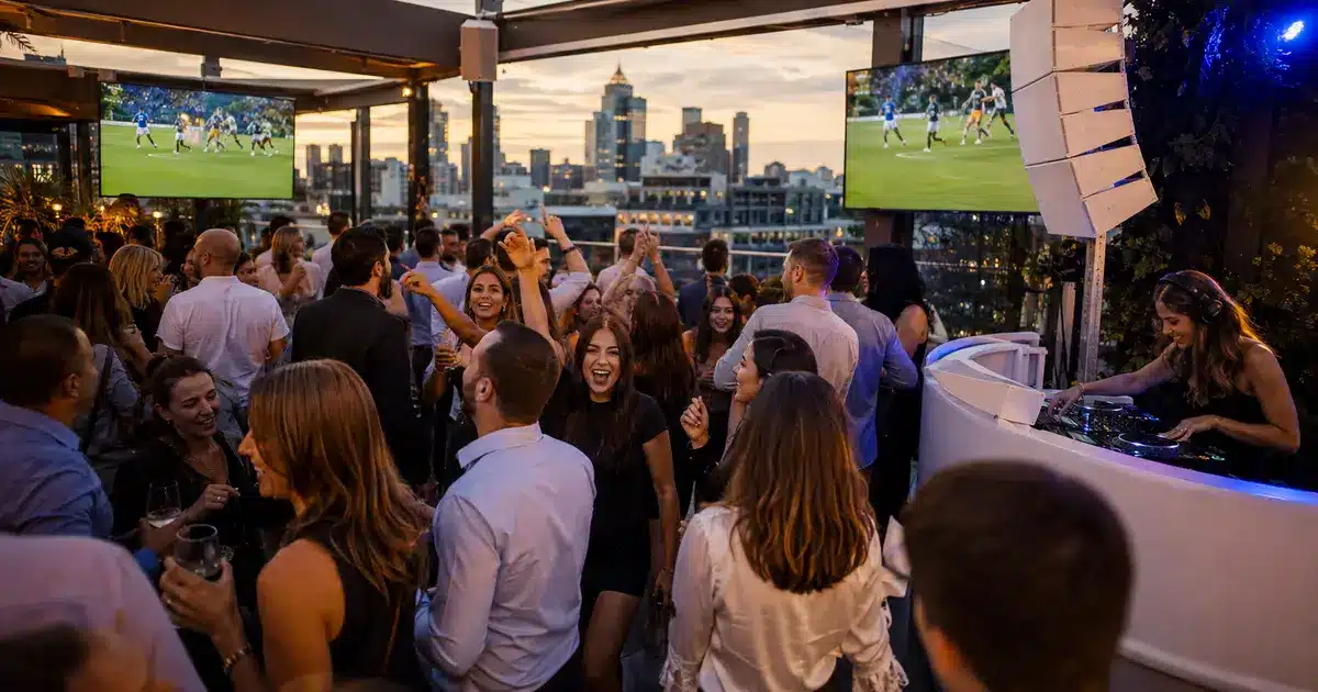 Event DJ performing at a Melbourne rooftop footy finals viewing party