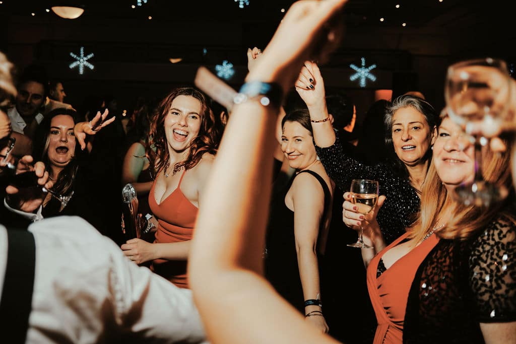 Corporate Christmas party guests dancing and enjoying music in Melbourne