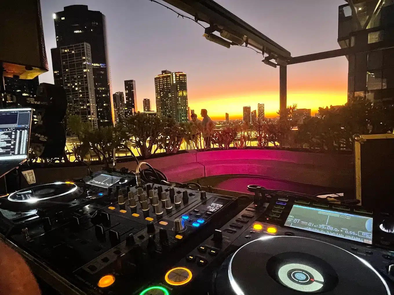DJ equipment at a Melbourne rooftop party at sunset